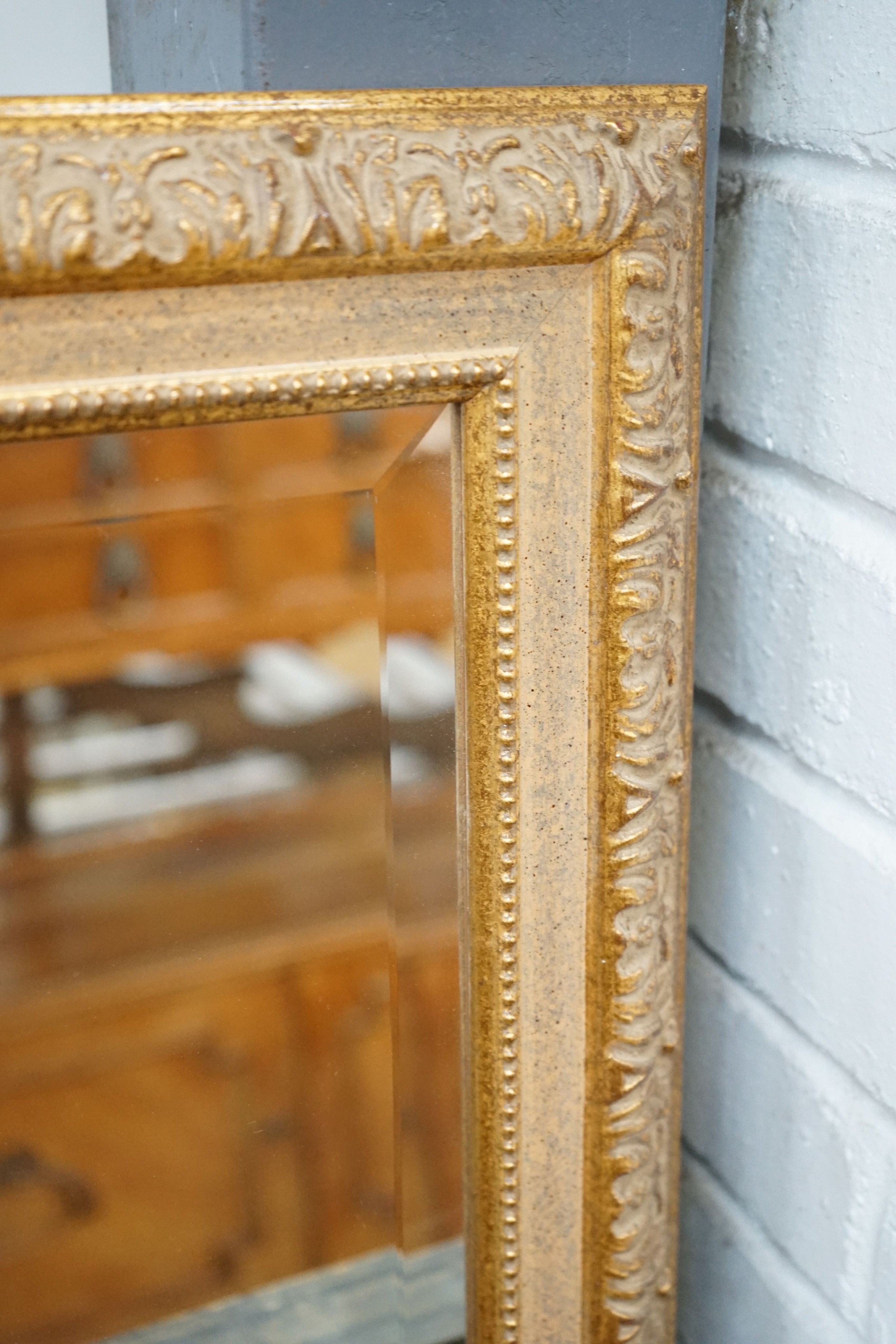 A reproduction gilt framed wall mirror, width 103cm, height 135cm